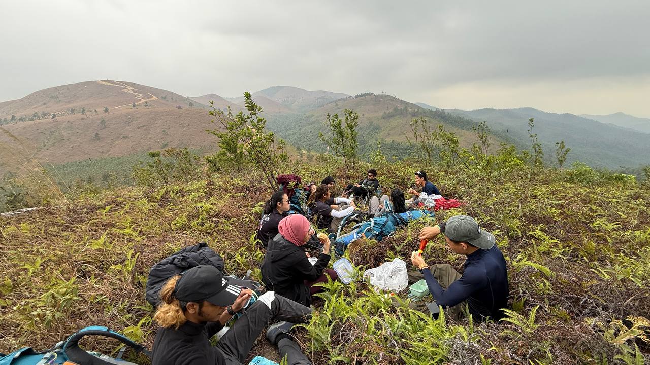 Group photo of everyone taking a break from trekking