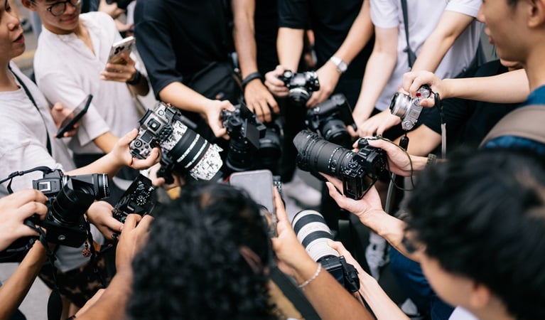 Photowalk attendees gather to take a group photo with their equipment