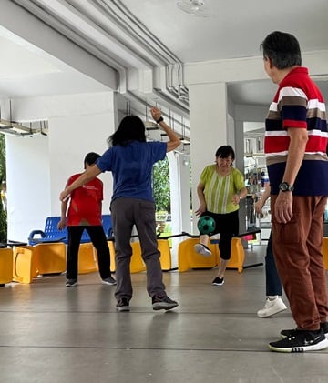 Void deck transformed into a human foosball arena for the seniors