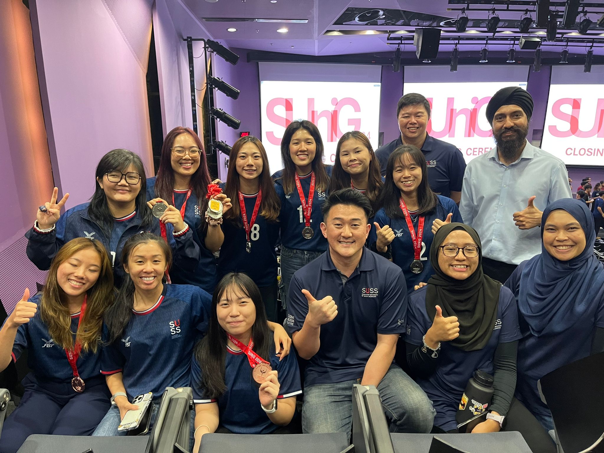 SUSS Women's Badminton and Tchoukball teams proudly received their medals