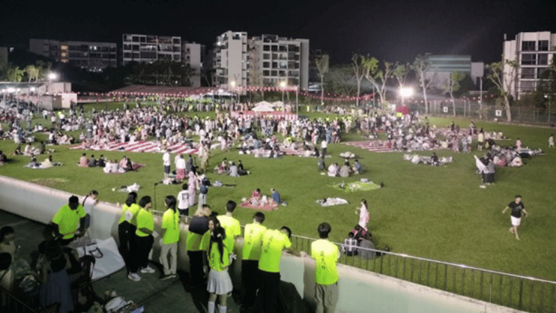 Japanese families and volunteers alike gather around the field to enjoy and join in the Bon-Odori dance