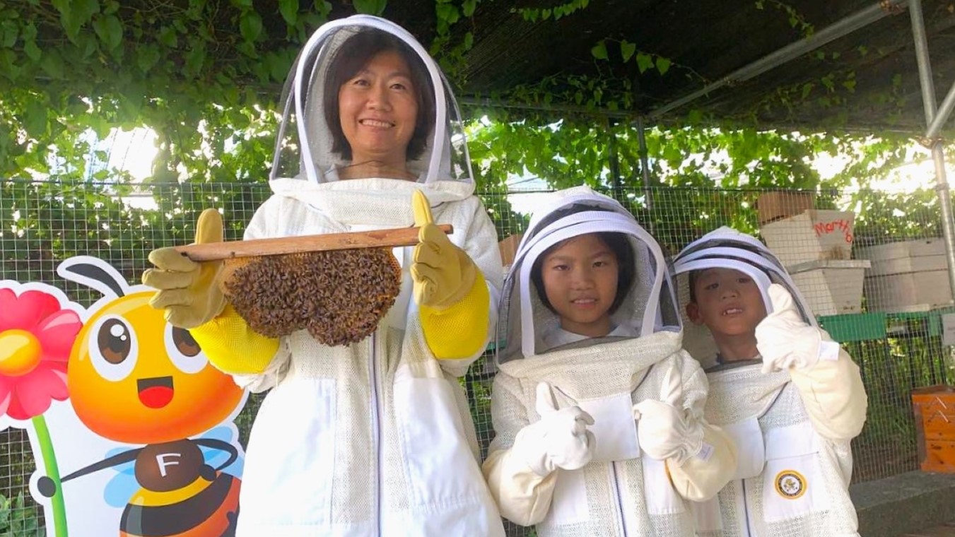 Children learning hands-on how to handle bees at our exciting Bee farm experience!