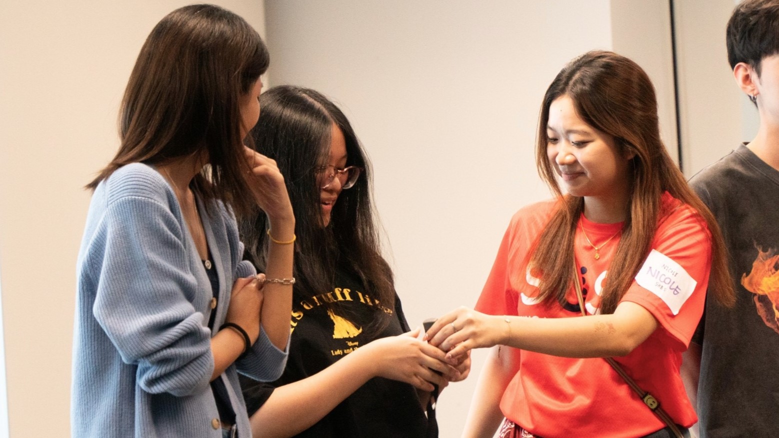 Freshmen engaging in conversation with a senior student.