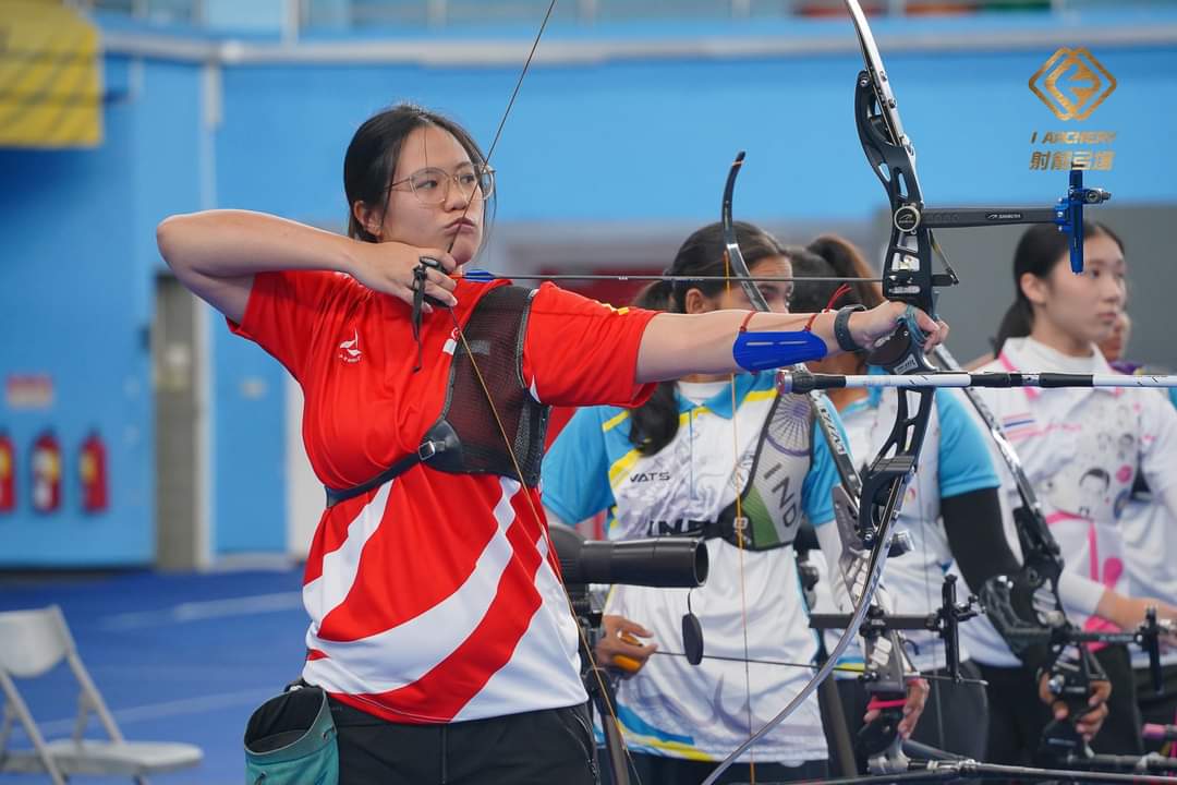 Isabel Tang steadies herself, anticipating the perfect shot.