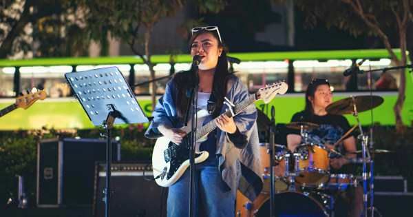 Arlene Queen S. Casais, SUSS Year 1 Digital Media student, and her band members from Sunset Paradise starting their set as the Orchard Road night lights come to life.