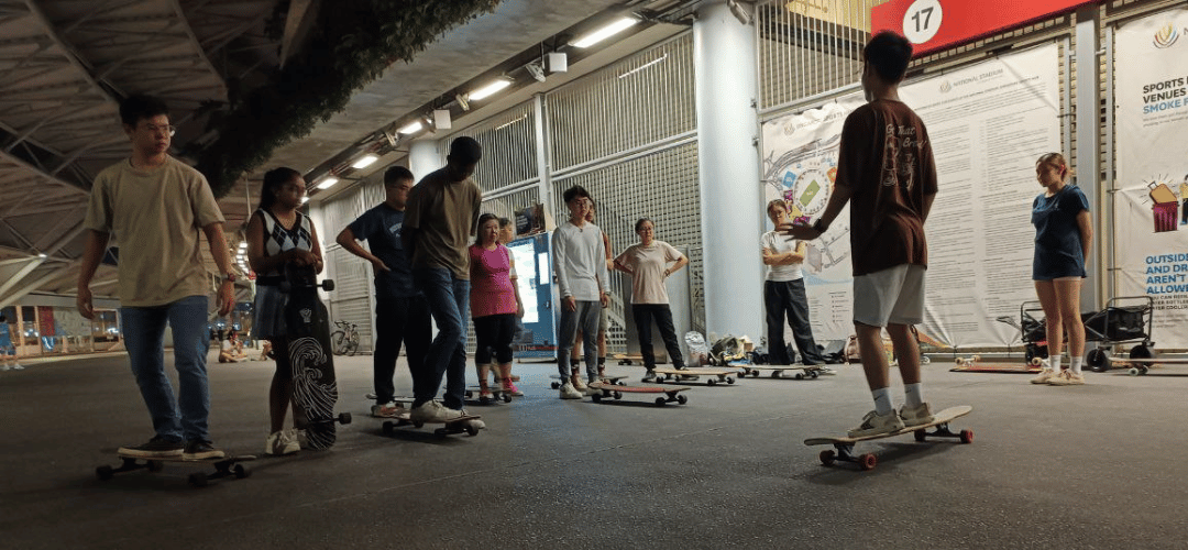 Coach guiding participants through longboarding techniques